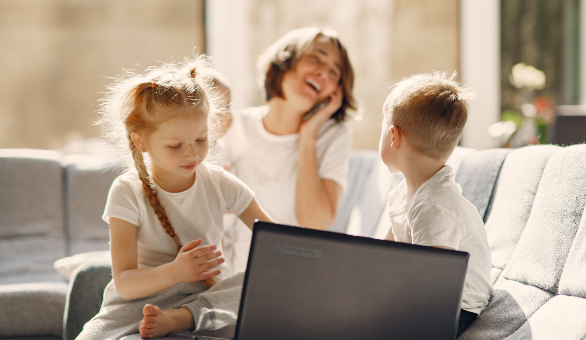 famiglia madre e tre figli davanti al pc felici per il welfare